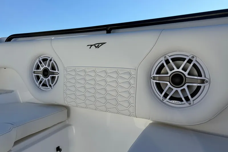 Slide: The Image of 2026 Tidewater 302 CC Adventure boat interior with JL Audio speakers and stylish upholstery. - 15
