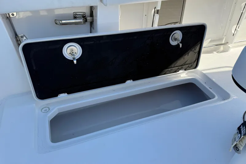 Slide: The Image of Open storage compartment on 2026 Tidewater 302 CC Adventure boat. - 21