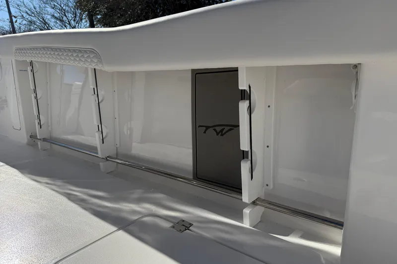 Slide: The Image of 2026 Tidewater 302 CC Adventure boat interior with storage compartments. - 22