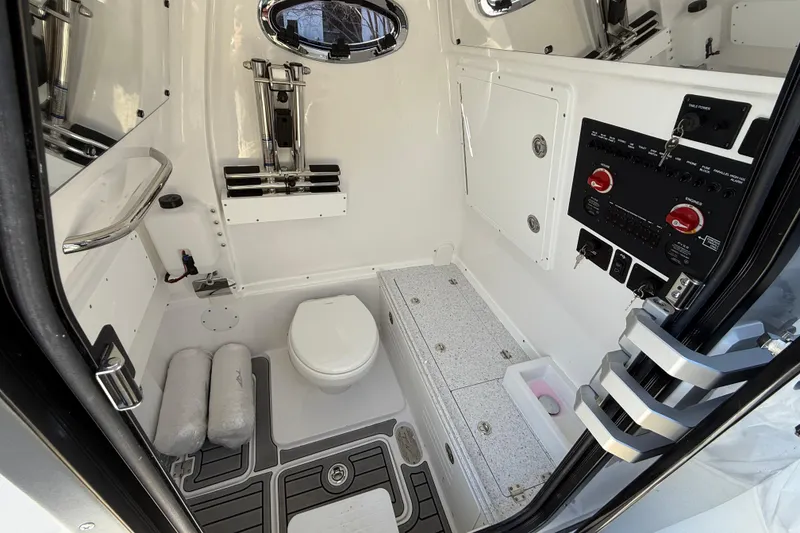 Slide: The Image of Interior of 2026 Tidewater 302 CC Adventure boat, featuring a compact marine bathroom. - 28