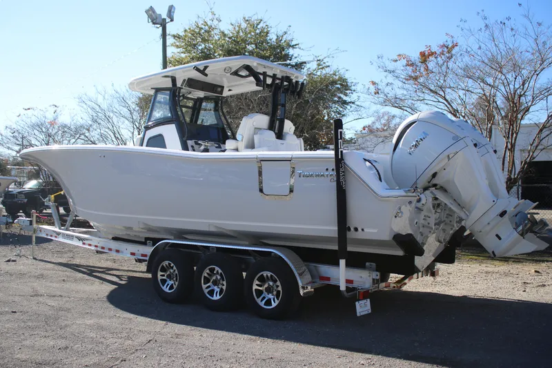 Slide: The Image of 2026 Tidewater 302 CC Adventure boat on trailer, featuring dual outboard engines. - 3