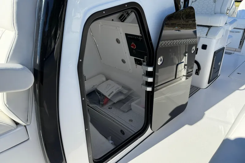 Slide: The Image of 2026 Tidewater 302 CC Adventure boat interior with open storage compartment. - 8