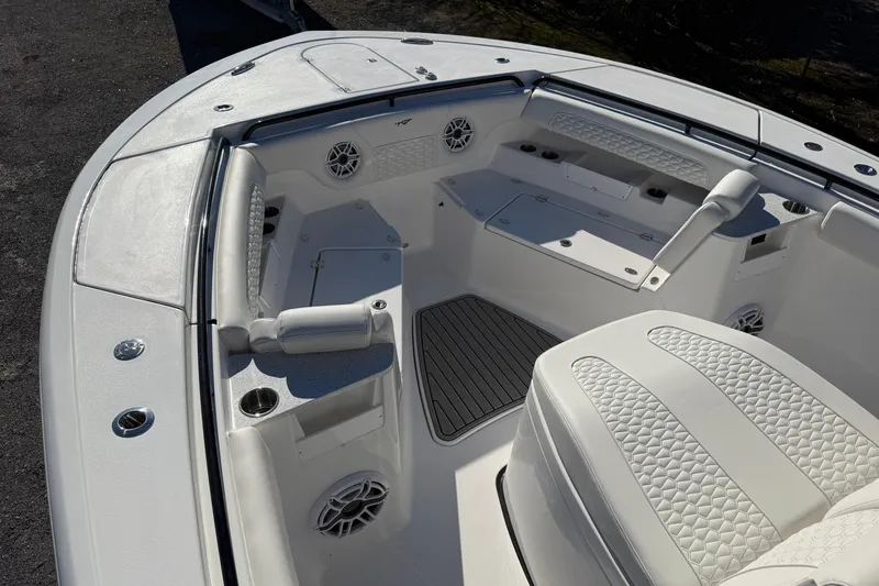 Slide: The Image of 2026 Tidewater 302 CC Adventure boat interior with cushioned seating and cup holders. - 9