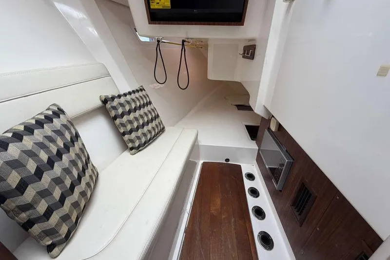Slide: The Image of Interior of 2018 Pursuit DC 365 Dual Console boat with cushioned seating and patterned pillows. - 17