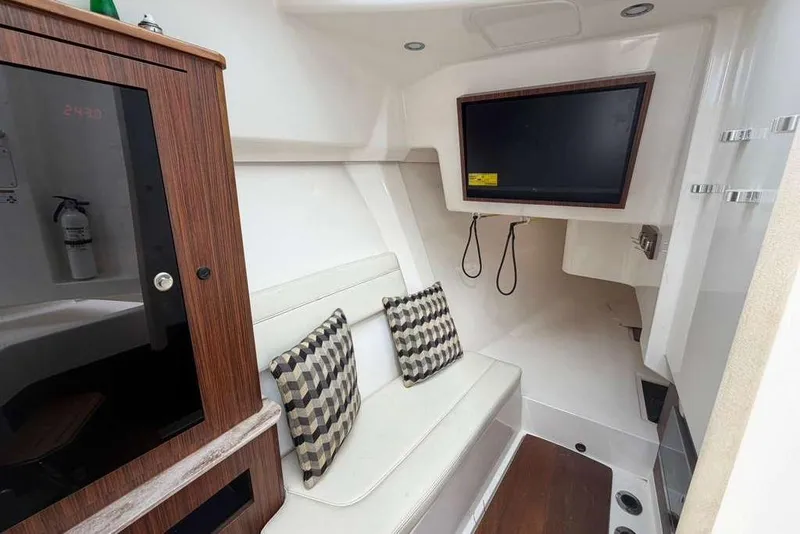 Slide: The Image of Interior of 2018 Pursuit DC 365 Dual Console boat with seating and TV. - 18