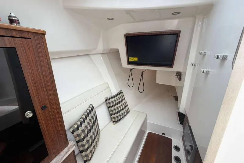 Slide: The Image of Interior of 2018 Pursuit DC 365 Dual Console with seating and TV. - 19