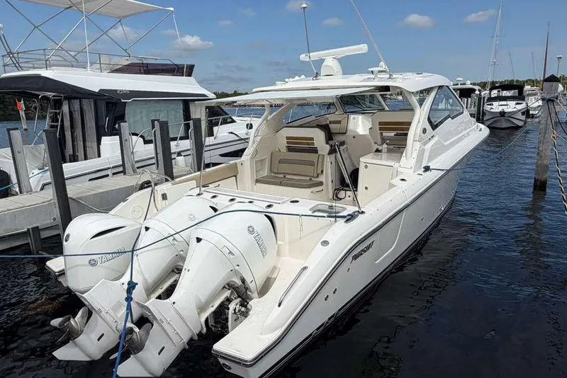 Slide: The Image of 2018 Pursuit DC 365 Dual Console boat docked with twin Yamaha outboard engines. - 22