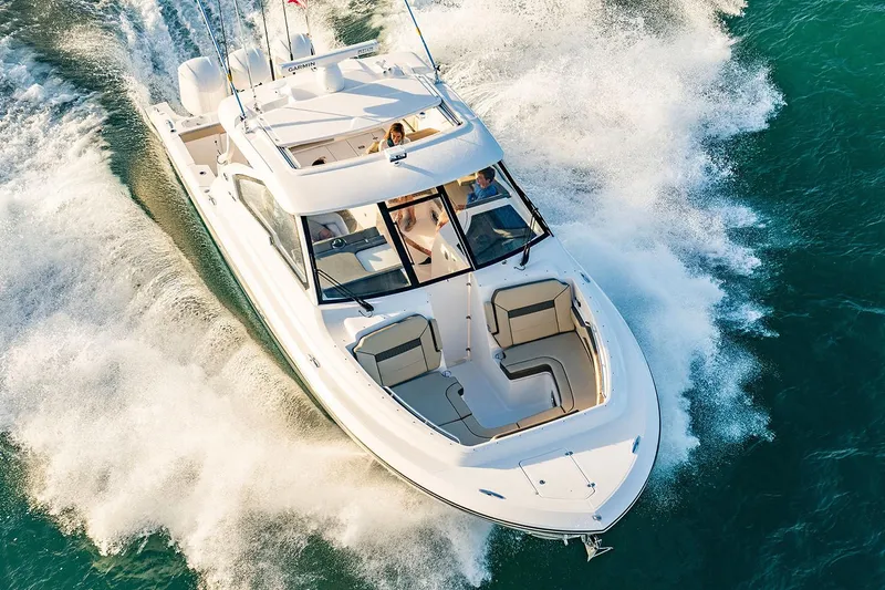 Slide: The Image of Manufacturer Provided Image: 2018 Pursuit DC 365 Dual Console boat cruising on water. - 3