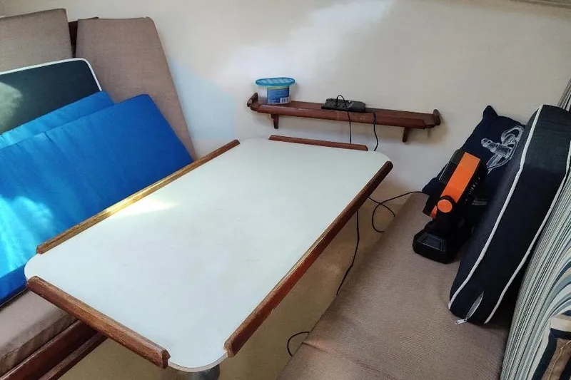Slide: The Image of 1987 Albin Family Cruiser interior with table, cushions, and shelf. - 17
