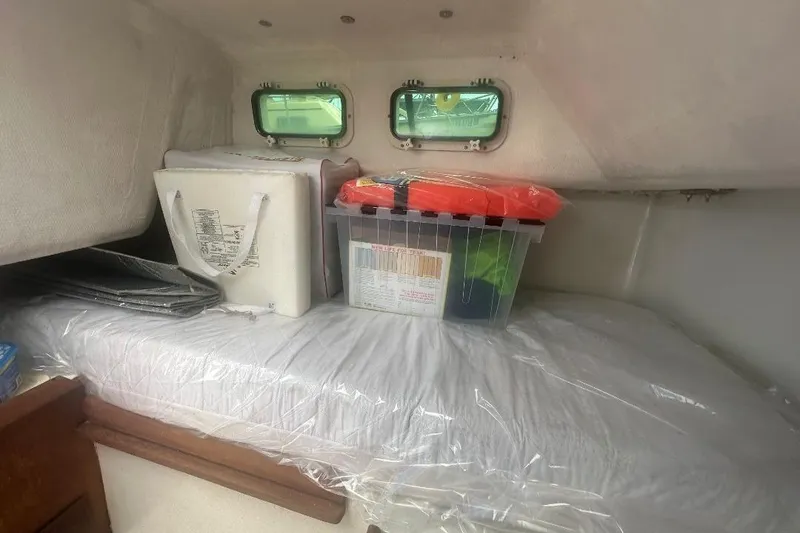 Slide: The Image of Interior of 1987 Albin Family Cruiser with storage boxes on a bed. - 29