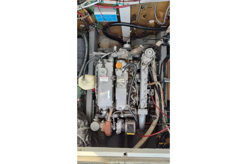 Slide: The Image of Engine compartment of a 1987 Albin Family Cruiser, showcasing mechanical components and wiring. - 31
