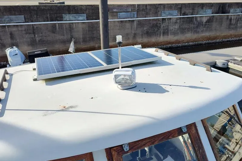 Slide: The Image of 1987 Albin Family Cruiser with solar panel on deck, docked at marina. - 6