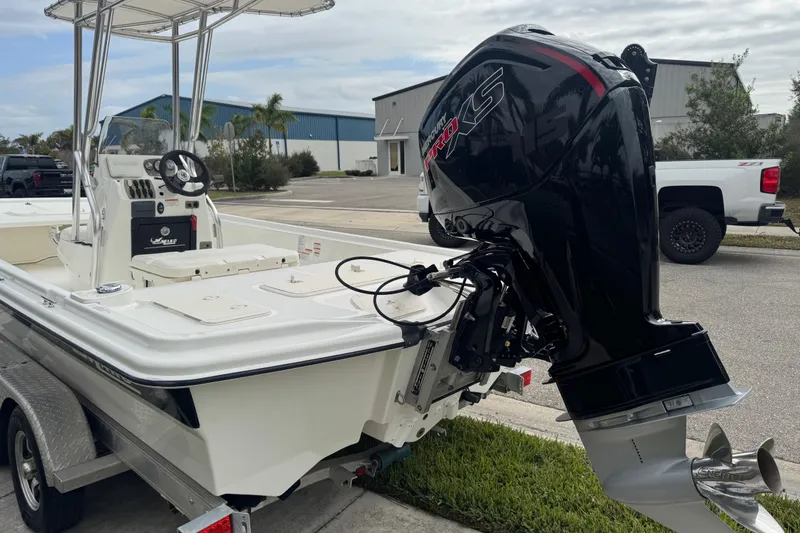Slide: The Image of 2017 Mako Pro Skiff 19 CC boat with powerful outboard motor on trailer. - 13