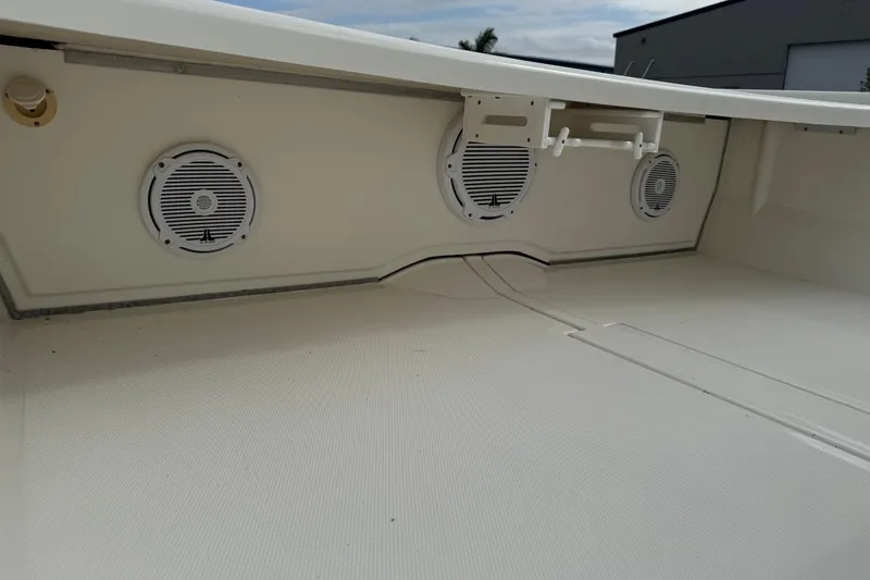 Slide: The Image of 2017 Mako Pro Skiff 19 CC interior with speakers and storage compartments. - 20