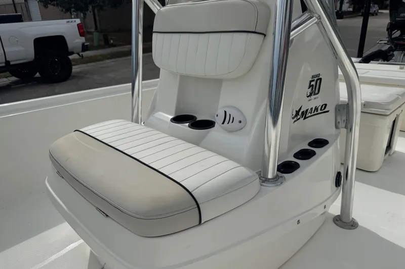 Slide: The Image of 2017 Mako Pro Skiff 19 CC boat interior with cushioned seating and cup holders. - 23