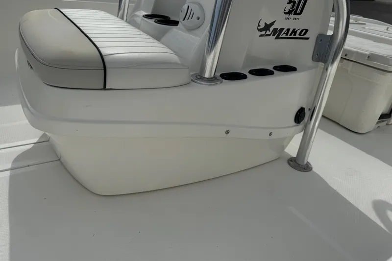 Slide: The Image of 2017 Mako Pro Skiff 19 CC boat interior with cushioned seating and console details. - 24