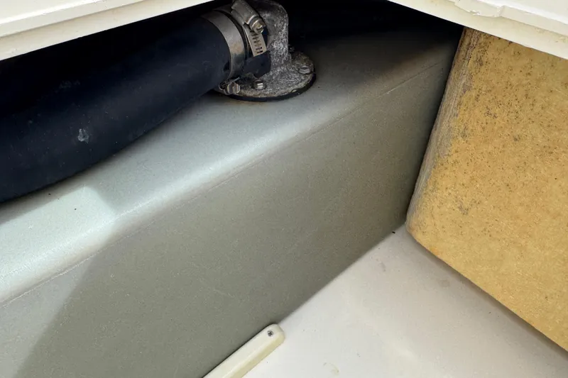 Slide: The Image of Close-up of 2017 Mako Pro Skiff 19 CC boat's internal compartment and hose connection. - 27