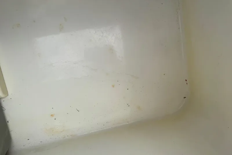 Slide: The Image of Interior of a 2017 Mako Pro Skiff 19 CC boat, showing a clean, white surface. - 30