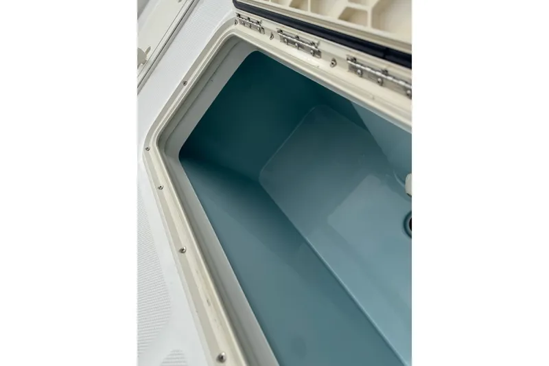 Slide: The Image of Open storage compartment on 2017 Mako Pro Skiff 19 CC boat. - 31