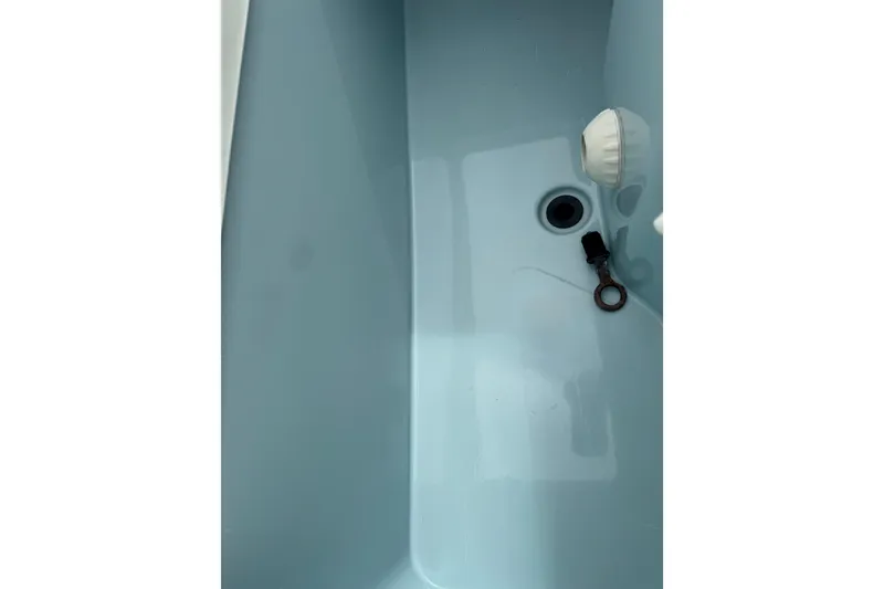 Slide: The Image of 2017 Mako Pro Skiff 19 CC interior detail with drain plug and fittings. - 32