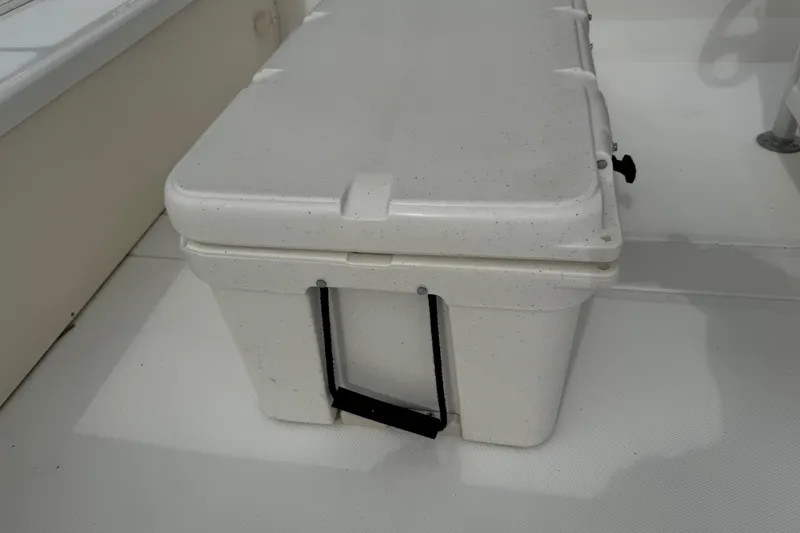 Slide: The Image of White cooler on 2017 Mako Pro Skiff 19 CC boat deck. - 38