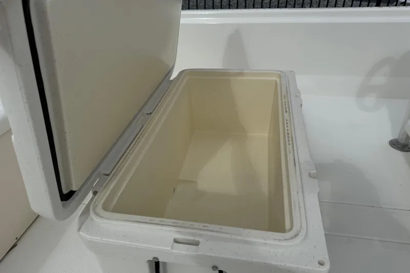 Slide: The Image of Open storage compartment on 2017 Mako Pro Skiff 19 CC boat. - 39