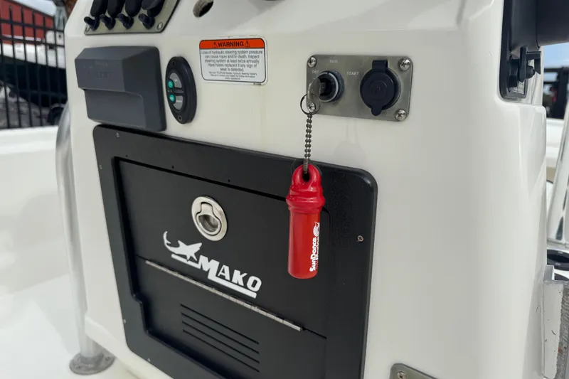 Slide: The Image of 2017 Mako Pro Skiff 19 CC console with controls and safety key. - 40