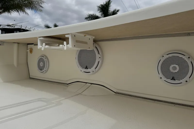 Slide: The Image of 2017 Mako Pro Skiff 19 CC boat interior with mounted speakers and storage. - 42