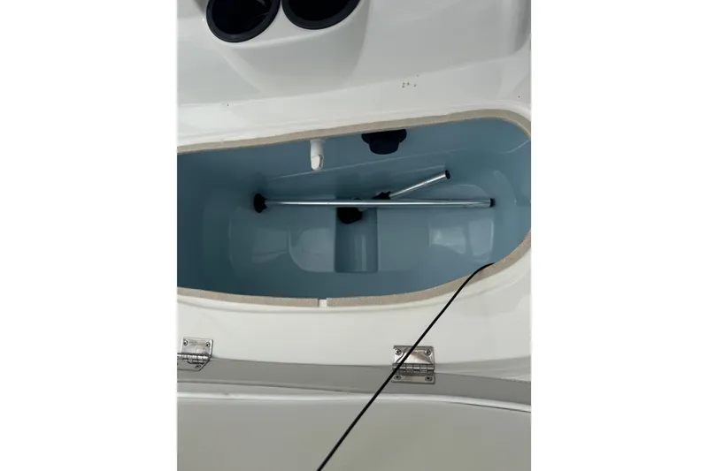 Slide: The Image of 2017 Mako Pro Skiff 19 CC storage compartment with metal rod inside. - 47