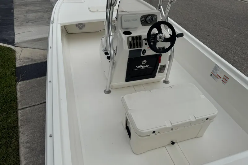 Slide: The Image of 2017 Mako Pro Skiff 19 CC boat interior with steering console and storage. - 59