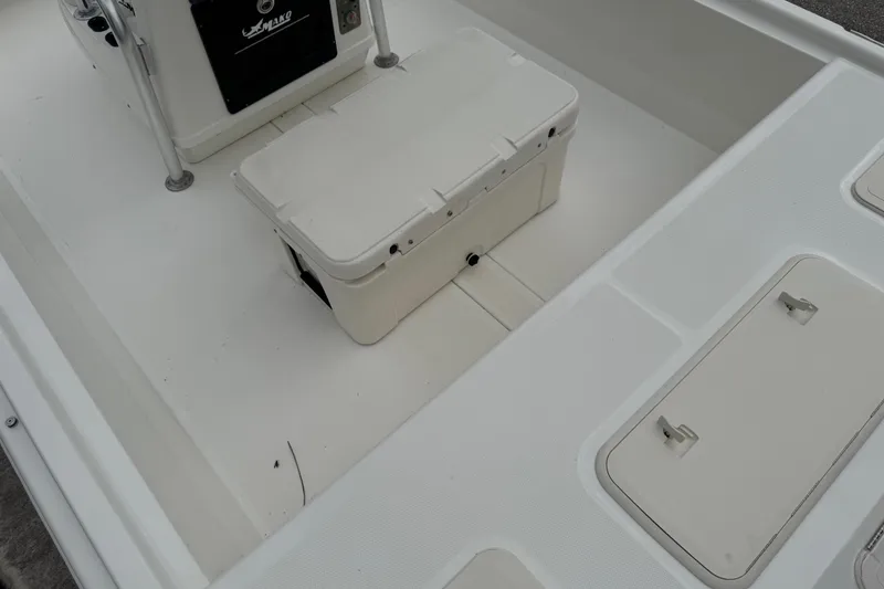 Slide: The Image of 2017 Mako Pro Skiff 19 CC interior with storage compartments and cooler. - 60