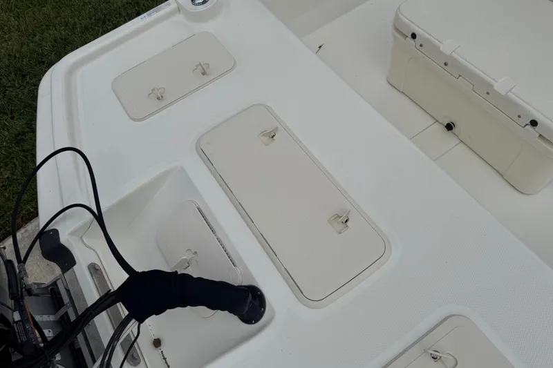 Slide: The Image of 2017 Mako Pro Skiff 19 CC boat deck with storage compartments and cooler. - 63