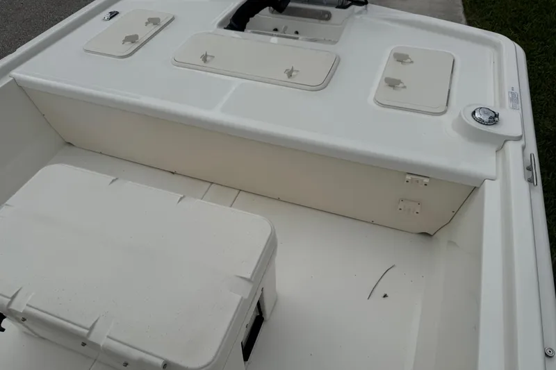 Slide: The Image of 2017 Mako Pro Skiff 19 CC boat interior with storage compartments and seating. - 66