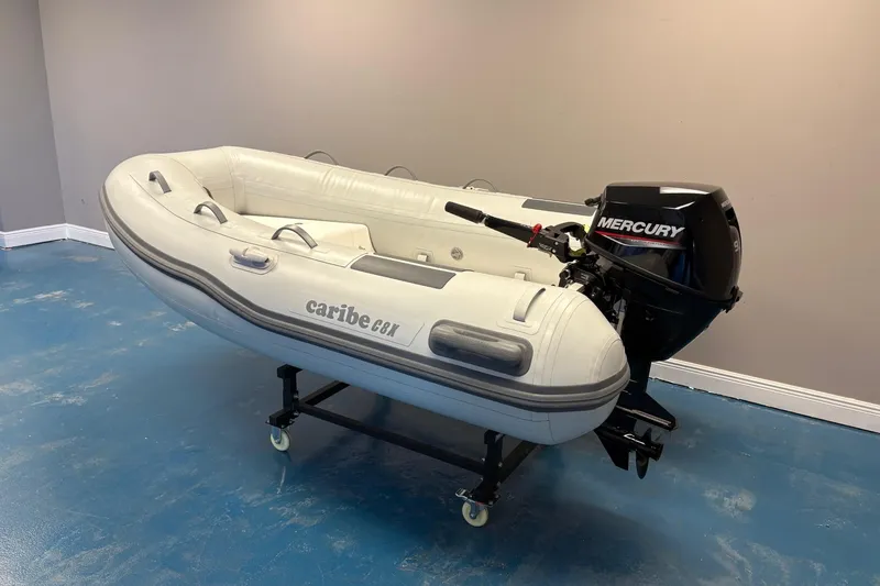 Slide: The Image of Inflatable Caribe 8X boat with Mercury motor, 2025 model, displayed indoors on a stand. - 3