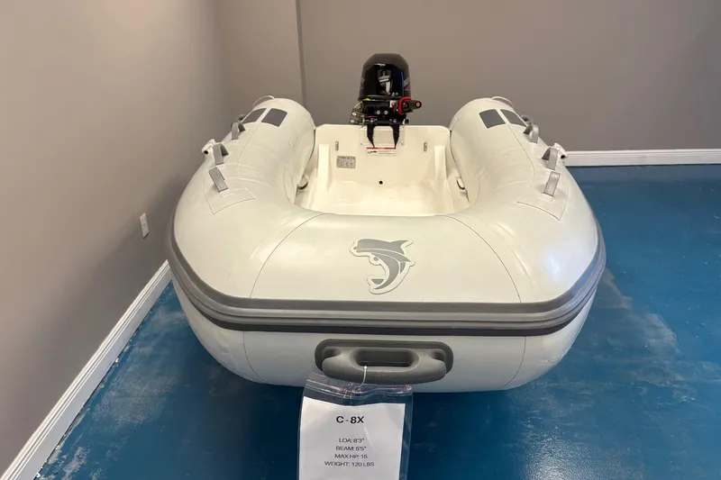 Slide: The Image of 2025 Caribe 8X inflatable boat in showroom, featuring sleek design and compact size. - 4