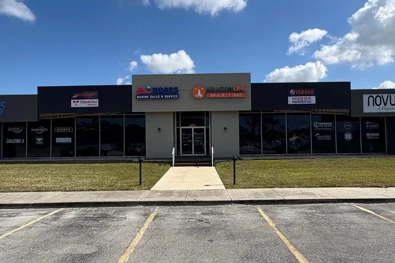 Slide: The Image of Storefront of marine sales and service shop under a clear blue sky. - 7