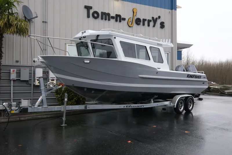 The Image of 2026 KingFisher 2825 Coastal Express boat on trailer at dealership. - 1
