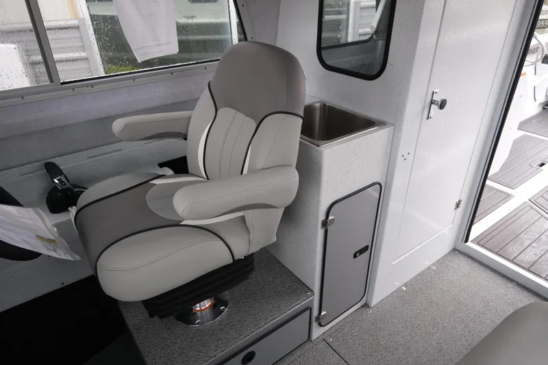 Slide: The Image of Interior of 2026 KingFisher 2825 Coastal Express boat with captain's chair and sink. - 12