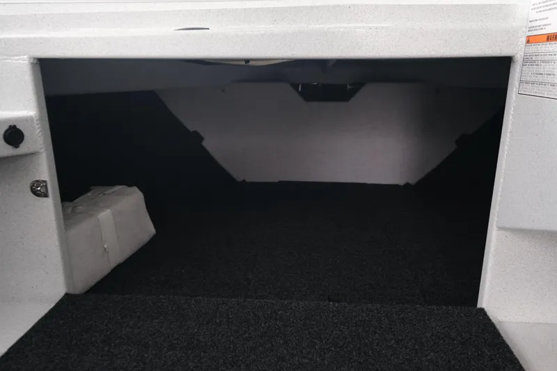 Slide: The Image of 2026 KingFisher 2825 Coastal Express interior storage compartment, featuring spacious design and carpeted flooring. - 15