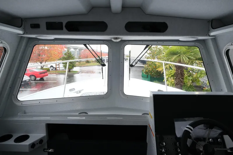 Slide: The Image of Interior view of 2026 KingFisher 2825 Coastal Express boat, showcasing dashboard and windshield. - 16