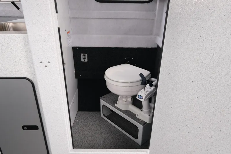 Slide: The Image of 2026 KingFisher 2825 Coastal Express boat interior with compact marine toilet. - 18