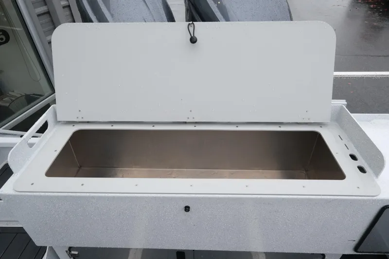 Slide: The Image of Open storage compartment on 2026 KingFisher 2825 Coastal Express boat. - 21