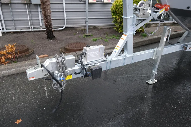 Slide: The Image of Trailer hitch of 2026 KingFisher 2825 Coastal Express on wet pavement. - 23