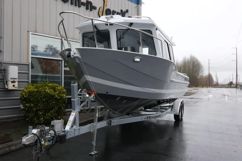 Slide: The Image of 2026 KingFisher 2825 Coastal Express boat on trailer, parked outside a building. - 3