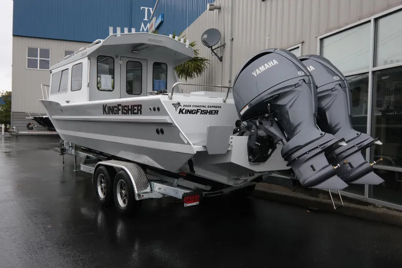 Slide: The Image of 2026 KingFisher 2825 Coastal Express boat with dual Yamaha engines on a trailer. - 4