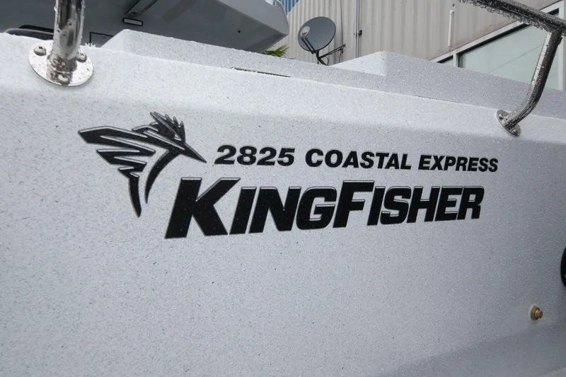 Slide: The Image of 2026 KingFisher 2825 Coastal Express boat logo on a textured surface. - 6