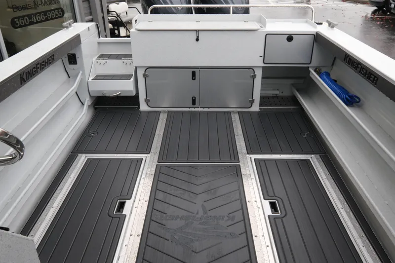 Slide: The Image of 2026 KingFisher 2825 Coastal Express boat interior with storage compartments and non-slip flooring. - 8