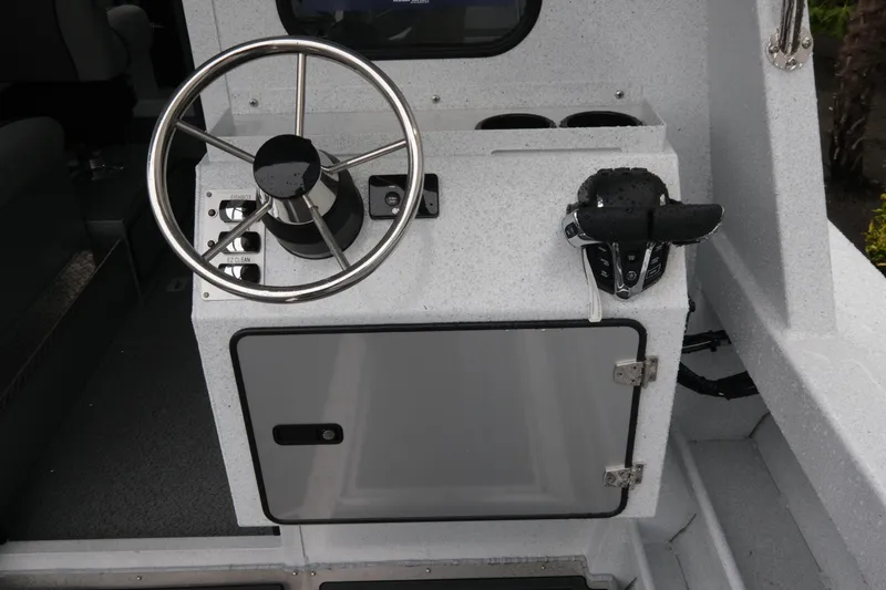 Slide: The Image of Steering console of 2026 KingFisher 2825 Coastal Express boat, featuring modern controls. - 9