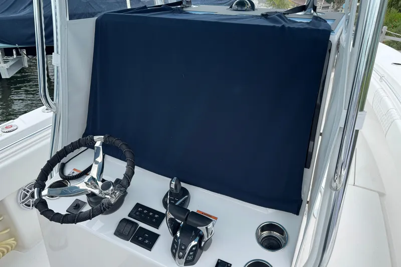 Slide: The Image of 2024 Contender 30 Tournament boat helm with covered console and steering wheel. - 12