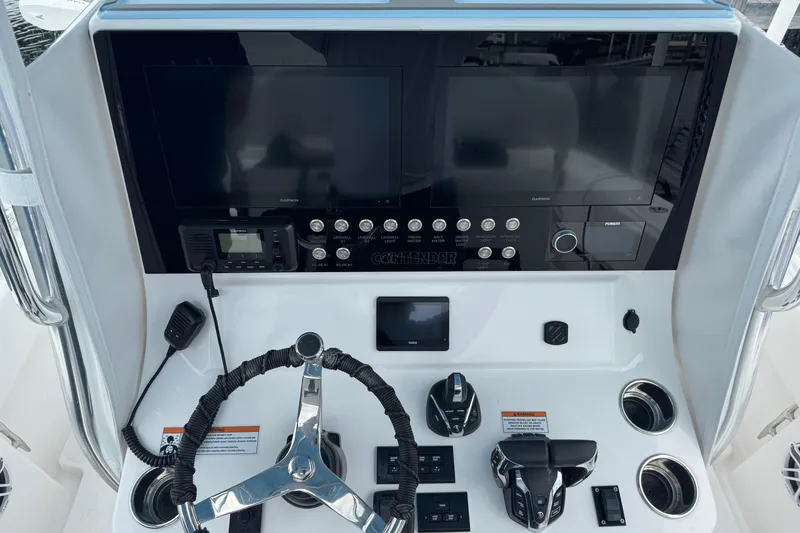 Slide: The Image of 2024 Contender 30 Tournament boat dashboard with advanced controls and navigation screens. - 13
